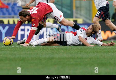 AS Roma s Francesco Totti top and Cagliari s Michele Canini battle