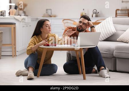 Young couple discussing family budget at home Stock Photo