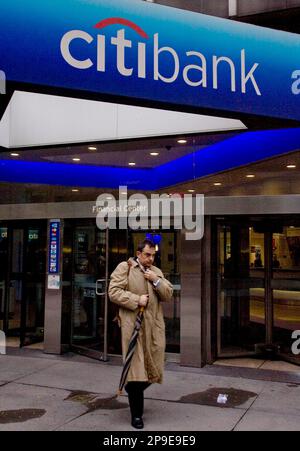 A man walks out of a Citibank branch in downtown Washington on November 24,  2008. The . government agreed to pump $20 billion into Citigroup and  will guarantee hundreds of billions of