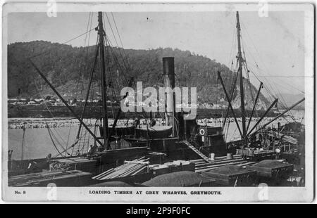 Postcard of Loading timber at Greymouth Port, Westland, New Zealand, probably in the 1930s. Stock Photo