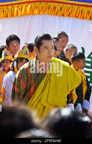 Bhutan's fifth King Jigme Khesar Namgyal Wangchuk, left, talks to Prime  Minister Jigmi Y. Thinley, while participating in the traditional sport of  archery during celebrations following the coronation ceremony in Thimpu,  Bhutan