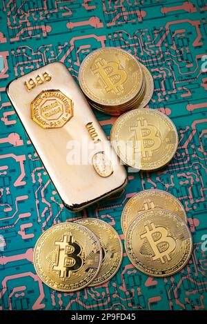 Gold Bar And Bit Coins On Circuit Board Still Life Stock Photo
