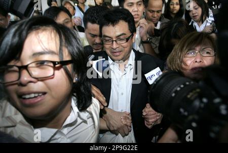 Abdul Razak Baginda, center, with his wife Mazlinda Makhzan is escorted ...