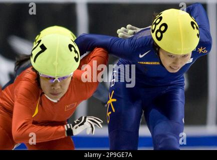 South Korea's Shin Sae-bom, right, edges past China's Zhou Yang to