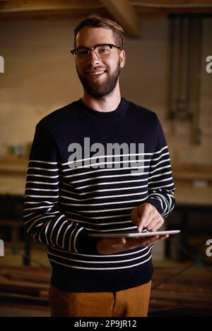 Using touchscreen technology. a hipster using a touchscreen device. Stock Photo