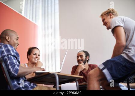 Theyre an easy going study group. a group of university students studying together. Stock Photo