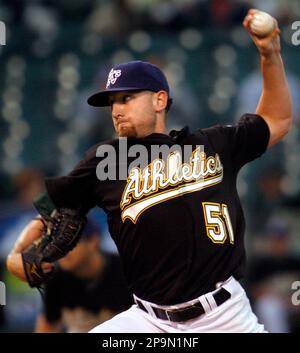 Former Oakland Athletics pitcher Dallas Braden wears a jersey of