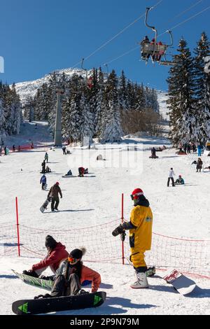 People, visitors and skiers, enjoying the sunny Winter day at Aleko Hut in Vitosha Mountain above Sofia, Bulgaria, Eastern Europe, Balkans, EU Stock Photo