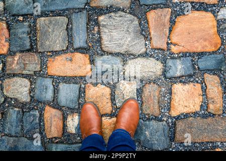 The pavement of granite stone. Paved roadway street, texture, background, selective focus. Stock Photo