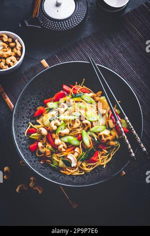 Stir fry noodles with chicken, vegetables and  roasted cashew nuts Stock Photo