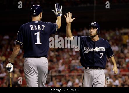 HOT START: Milwaukee's J.J. Hardy is congratulated by teammate Corey Hart  after scoring the game winning