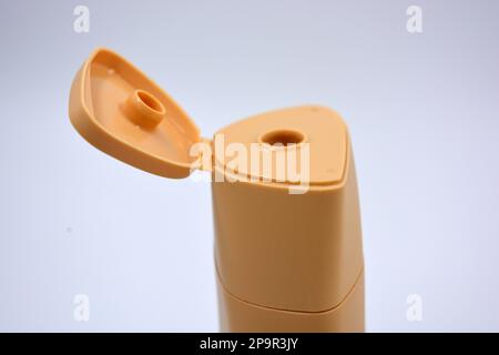 Beautiful brown plastic bottle, packaging from shampoo, body care cream is located on a white background. Stock Photo