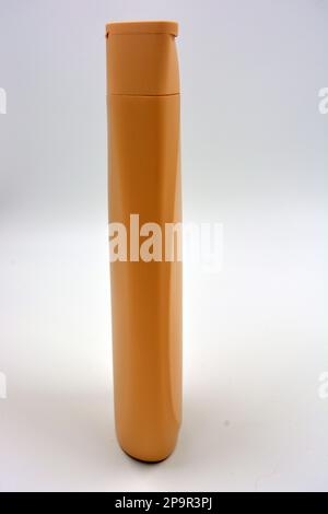 Beautiful brown plastic bottle, packaging from shampoo, body care cream is located on a white background. Stock Photo