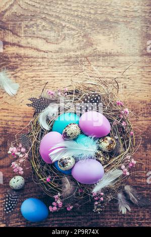 Happy Easter - nest with Easter eggs on wooden background with copy space Stock Photo