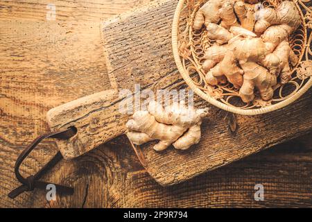 Fresh organic ginger roots on wooden background. Stock Photo