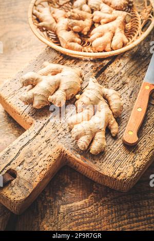 Fresh organic ginger roots on wooden background. Stock Photo