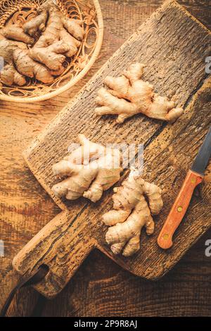 Fresh organic ginger roots on wooden background. Stock Photo