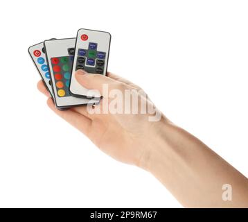 Woman holding remote controls on white background, closeup Stock Photo