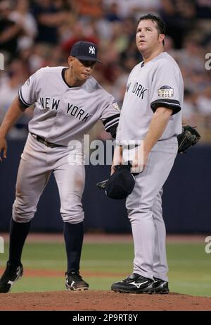 New York Yankees third baseman Alex Rodriguez, left, gives