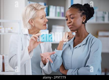 Suggestion, help and black woman with medicine from a pharmacist, dosage information and recommendation. Medical, sick and doctor reading label on a Stock Photo