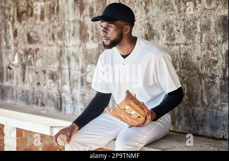 Black man, baseball or catch glove on sports, stadium or arena bench for game, match or serious competition. Concentration, athlete or softball player Stock Photo