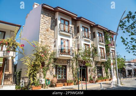 Datca, Mugla, Turkey – August 19, 2022. Residential building along Ataturk Caddesi street in Datca resort town of Mugla, Turkey. The building houses a Stock Photo