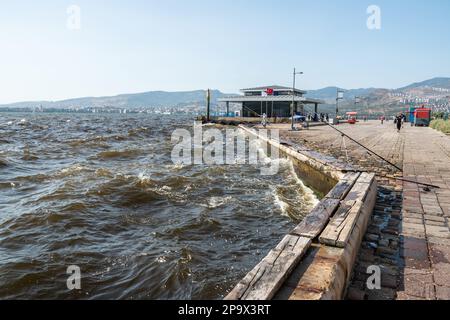 Aegean waterfront and promenade in Alsancak neighborhood of Izmir, Turkey. View on a stormy day, with unidentifiable figures of people. Stock Photo