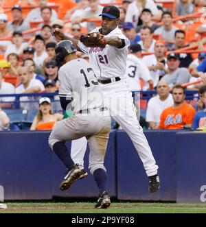 New York Mets first baseman Carlos Delgado, right, is greeted at