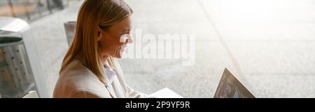 Woman freelance programer working on laptop while sitting in cafe. Data done right Stock Photo