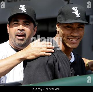 Bulls draft pick Derrick Rose dons a White Sox hat as he stands beside  Chicago White Sox manager Ozzie Guillen during pre-game activities at U.S.  Cellular Field in Chicago, Illinois, Friday, June