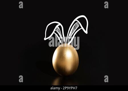 Happy Easter, Rabbits's ears, gold eggs. Stock Photo
