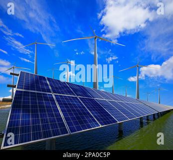 Wind turbines and solar panels at sunset. renewable energy concept ...