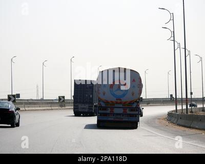 Giza, Egypt, March 9 2023: A big truck with a container tank with petroleum products, a lorry on the highway with a container on it delivering the pro Stock Photo
