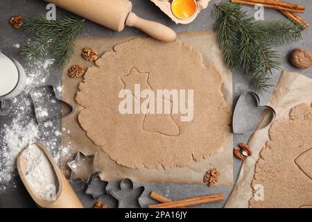 Homemade Christmas cookies. Flat lay composition with dough on grey table Stock Photo