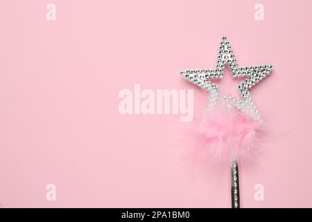 Beautiful silver magic wand with feather on pink background, top view. Space for text Stock Photo