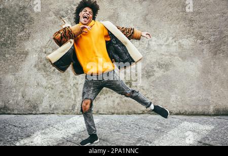 Young african guy having fun dancing outdoor - Soft focus on face Stock Photo