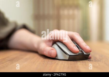 Hand, fingers on computer mouse on wooden desk. SEO, engine optimization and search query concept. High quality photo Stock Photo
