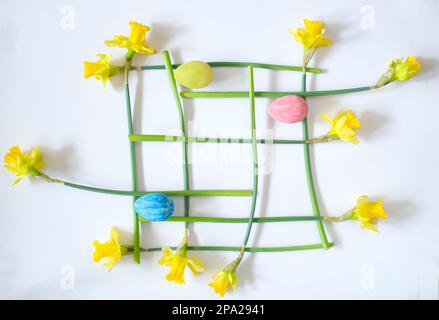 easter decoration with handpainted easter eggs and daffodil flowers,modern art inspired flat lay Stock Photo