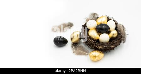Easter golden and black eggs, feather. Stock Photo