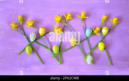 easter decoration with handpainted easter eggs and daffodil flowers,flat lay Stock Photo