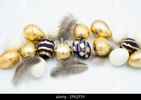 Easter golden and black eggs, feather. Stock Photo