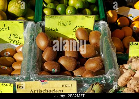 Kiwis and fruit with price tags at a market stall, Germany Stock Photo