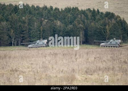 Two British army military AS90 (AS-90 Braveheart Gun Equipment 155mm L131) armoured self-propelled howitzer on a military exercise, Wiltshire UK Stock Photo