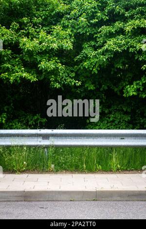 Closeup view of a metal guardrail and support posts along an urban ...