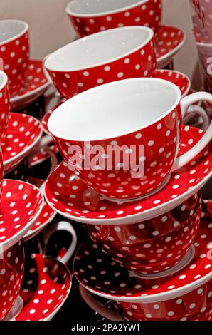 Stack of red with white dots coffee cups for sale in a houseware store. Display - Retail industry Stock Photo