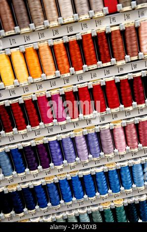 Set of multicolored threads for sewing - Many different colors sewing threads arranged in a palette. Hobby craft Stock Photo