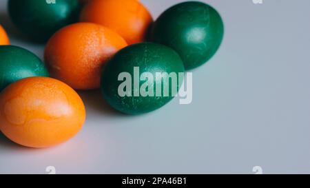 Small multi-colored Easter eggs on the kulich, festively decorated with colorful painted eggs paint, background nice Stock Photo