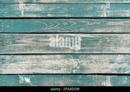 Wooden background. Old turquoise painted wooden plank surface, aged weathered cracked boards. Grunge shabby texture. Stock Photo