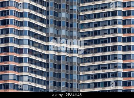 NYC Midtown: Ribbon windows and multi-colored brick form an abstract pattern at Horizon, a condo high-rise in Manhattan’s Murray Hill section. Stock Photo