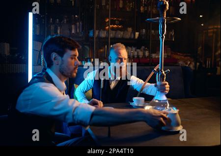 Good friends meeting in hookah lounge, relax concept Stock Photo